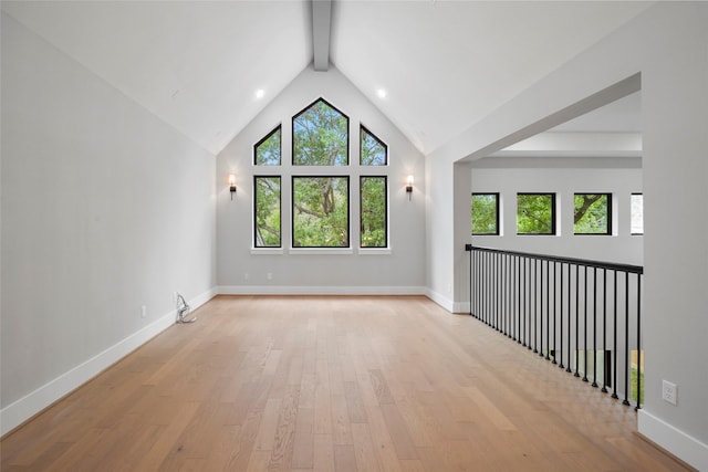 1957 Restridge Dr, Houston, TX 77055 - spare room featuring plenty of natural light, light wood-type flooring, beamed ceiling, baseboards, and high vaulted ceiling