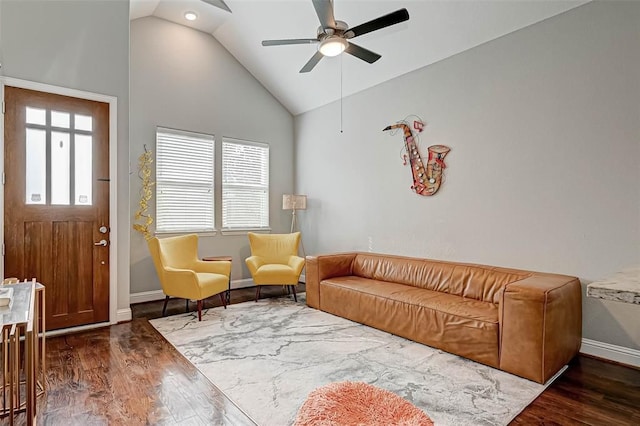 living room with high vaulted ceiling, ceiling fan, baseboards, and wood finished floors