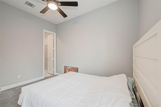 carpeted bedroom with ceiling fan, baseboards, and visible vents