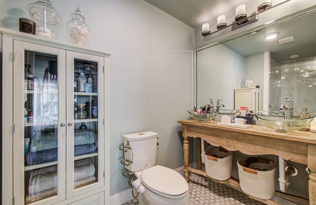 15708 Acapulco Dr, Jersey Village, TX 77040 - bathroom featuring toilet, a sink, and baseboards