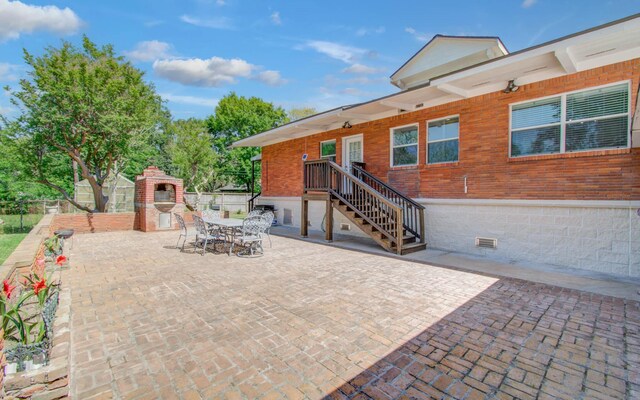 15708 Acapulco Dr, Jersey Village, TX 77040 - view of patio featuring a fireplace, fence, and outdoor dining space