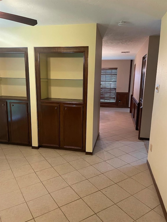 9948 Twin Shores Dr, Willis, TX 77318 - hallway featuring baseboards and light tile patterned floors