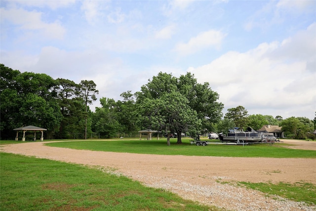 9948 Twin Shores Dr, Willis, TX 77318 - view of home's community with a yard, a gazebo, and dirt driveway