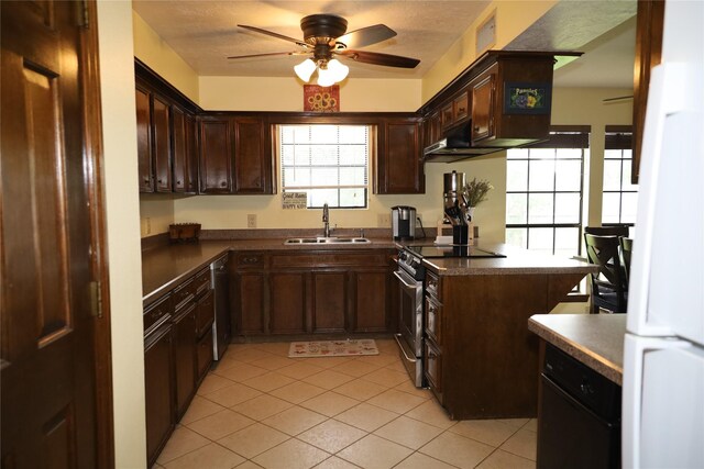 9948 Twin Shores Dr, Willis, TX 77318 - kitchen with a sink, stainless steel electric range, freestanding refrigerator, and dark countertops