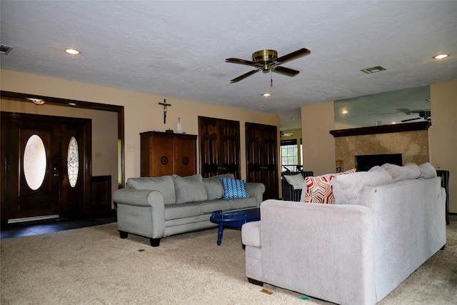 9948 Twin Shores Dr, Willis, TX 77318 - carpeted living area featuring recessed lighting, a ceiling fan, visible vents, and a fireplace
