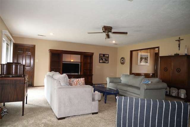 9948 Twin Shores Dr, Willis, TX 77318 - living area featuring visible vents, ceiling fan, and light colored carpet