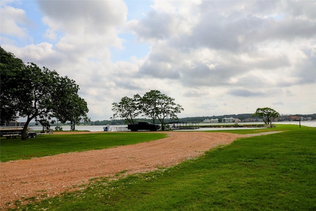 9948 Twin Shores Dr, Willis, TX 77318 - view of community with a lawn and a water view