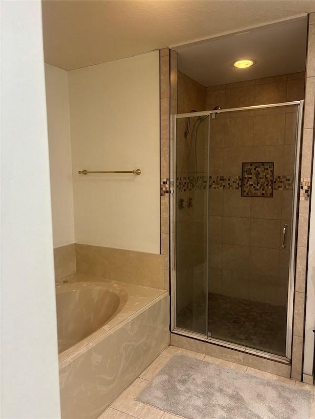 9948 Twin Shores Dr, Willis, TX 77318 - full bath featuring tile patterned floors, a shower stall, and a bath