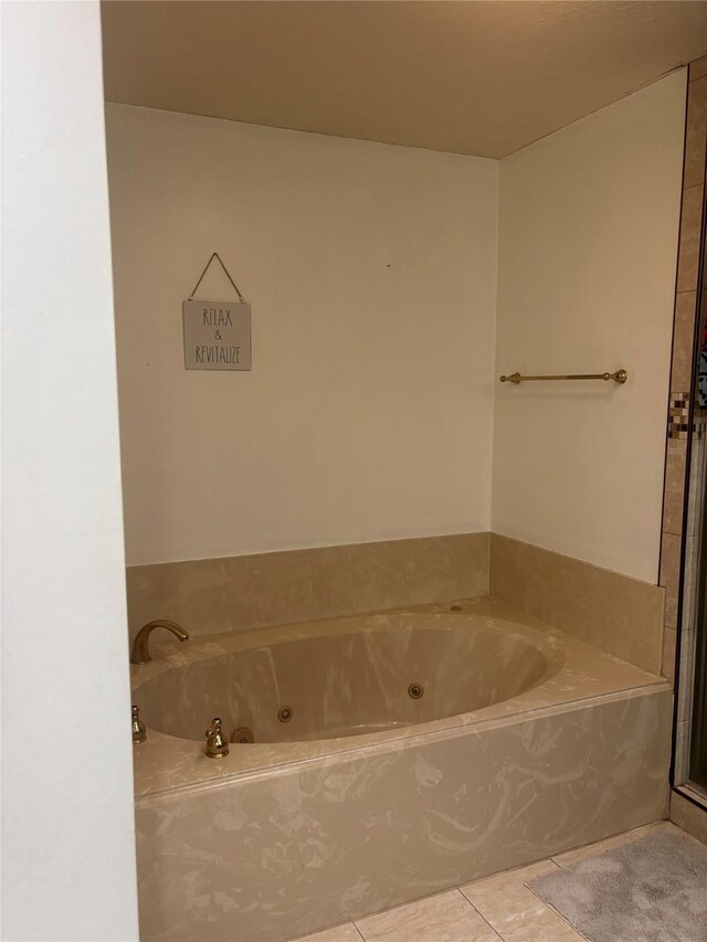 9948 Twin Shores Dr, Willis, TX 77318 - full bath with a tub with jets and tile patterned flooring