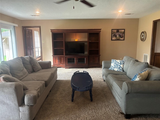9948 Twin Shores Dr, Willis, TX 77318 - carpeted living area with visible vents and ceiling fan