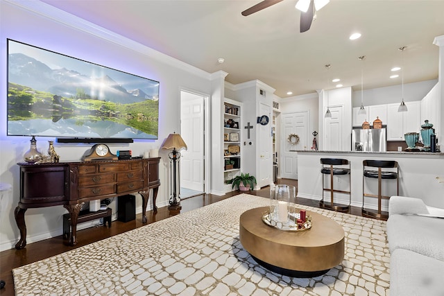 living room featuring wood finished floors, recessed lighting, ceiling fan, and crown molding