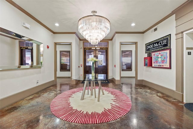 entrance foyer with an inviting chandelier, crown molding, visible vents, and baseboards