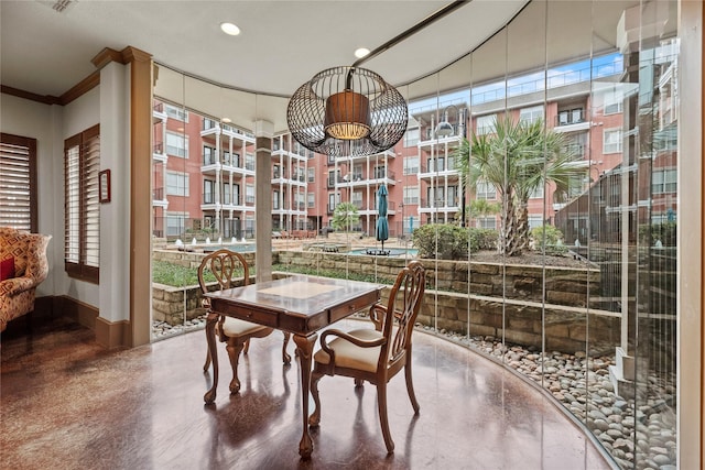 interior space with baseboards, recessed lighting, a chandelier, and ornamental molding