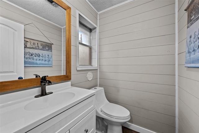 4702 Gulfway Dr, Baytown, TX 77521 - half bath with a textured ceiling, crown molding, wood walls, toilet, and vanity