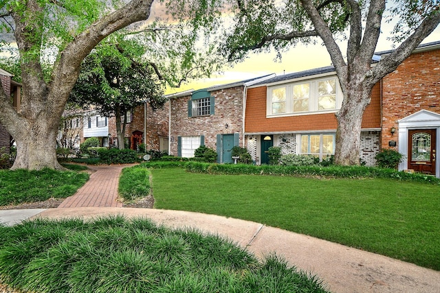 6415 Olympia Dr Unit 143, Houston, TX 77057 - view of front facade featuring brick siding and a front yard