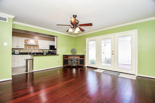 6415 Olympia Dr Unit 143, Houston, TX 77057 - unfurnished living room featuring hardwood / wood-style flooring, ceiling fan, ornamental molding, and visible vents