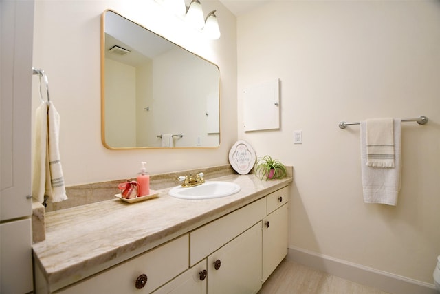 6415 Olympia Dr Unit 143, Houston, TX 77057 - bathroom with visible vents, baseboards, wood finished floors, and vanity