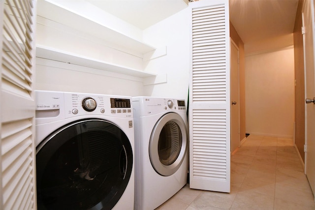 6415 Olympia Dr Unit 143, Houston, TX 77057 - washroom featuring washer and dryer, laundry area, and light tile patterned floors