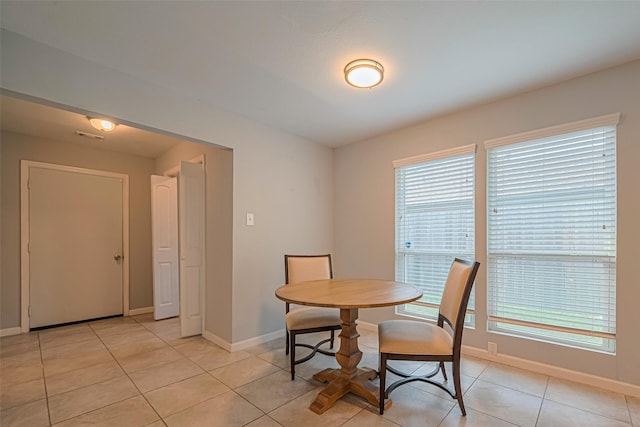 7730 Maple Tree Dr, Houston, TX 77088 - dining area featuring baseboards, healthy amount of natural light, and light tile patterned floors