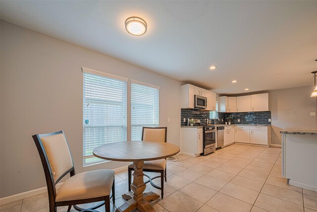 7730 Maple Tree Dr, Houston, TX 77088 - kitchen with appliances with stainless steel finishes, plenty of natural light, tasteful backsplash, white cabinetry, and recessed lighting