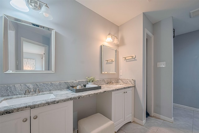 7730 Maple Tree Dr, Houston, TX 77088 - bathroom with tile patterned floors, double vanity, and baseboards