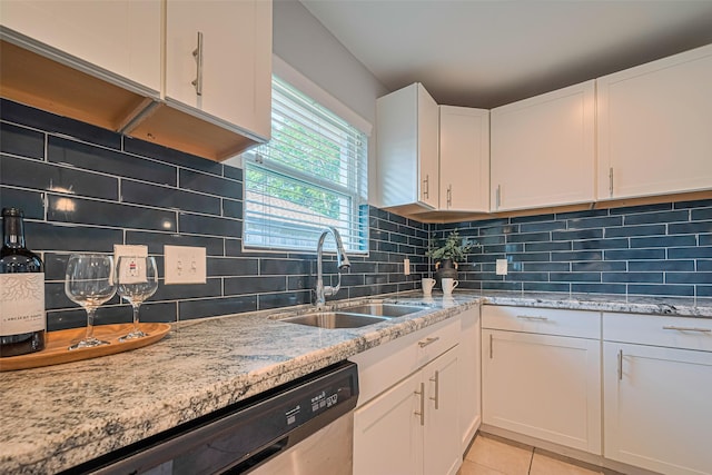 7730 Maple Tree Dr, Houston, TX 77088 - kitchen with a sink, stainless steel dishwasher, white cabinetry, light stone countertops, and light tile patterned floors