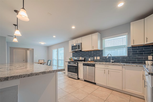 7730 Maple Tree Dr, Houston, TX 77088 - kitchen with appliances with stainless steel finishes, a sink, light tile patterned floors, backsplash, and recessed lighting