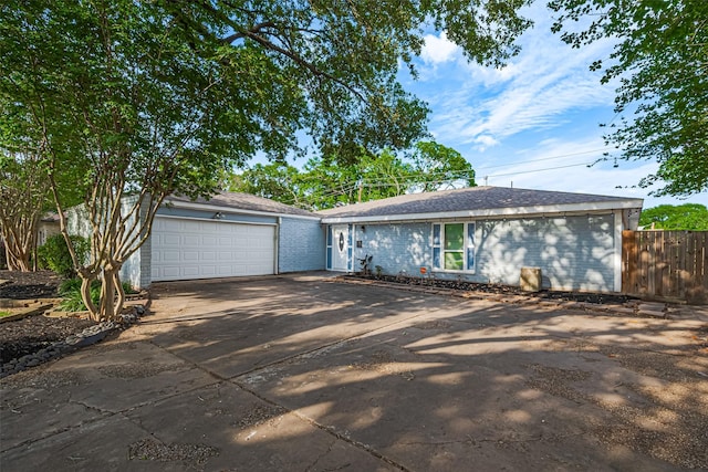 7730 Maple Tree Dr, Houston, TX 77088 - ranch-style house featuring concrete driveway, an attached garage, fence, and brick siding