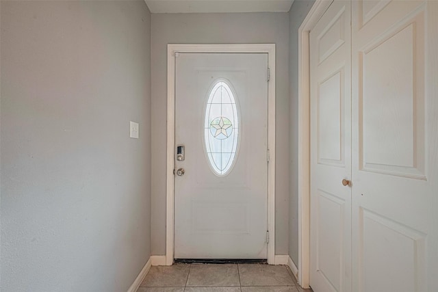 7730 Maple Tree Dr, Houston, TX 77088 - doorway featuring baseboards and light tile patterned flooring