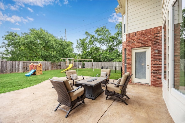 view of patio / terrace with a fenced backyard, a playground, and a fire pit