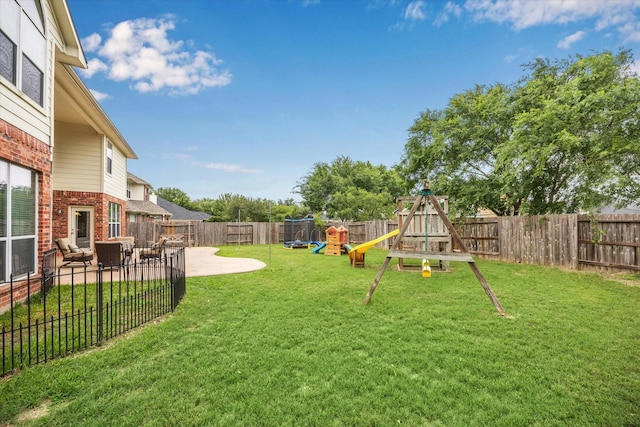 view of yard with a playground, a fenced backyard, and a patio area