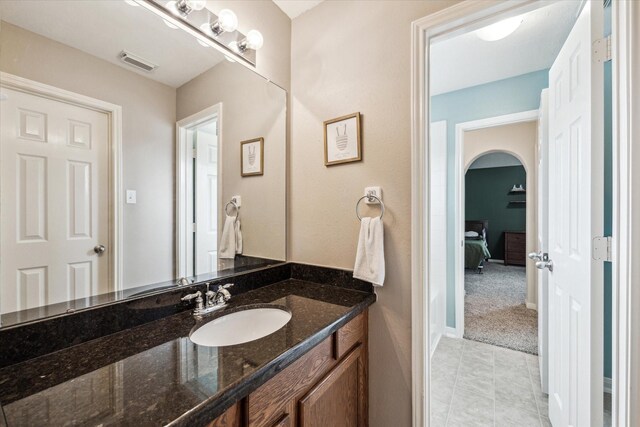 bathroom featuring visible vents, tile patterned flooring, and vanity