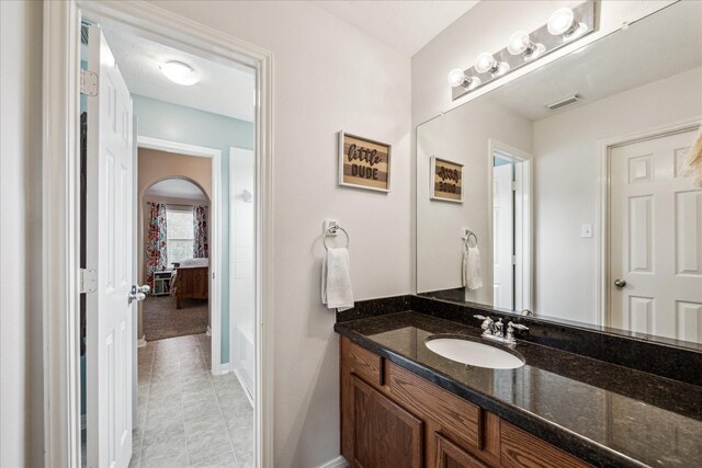 full bath with visible vents, baseboards, tile patterned floors, and vanity