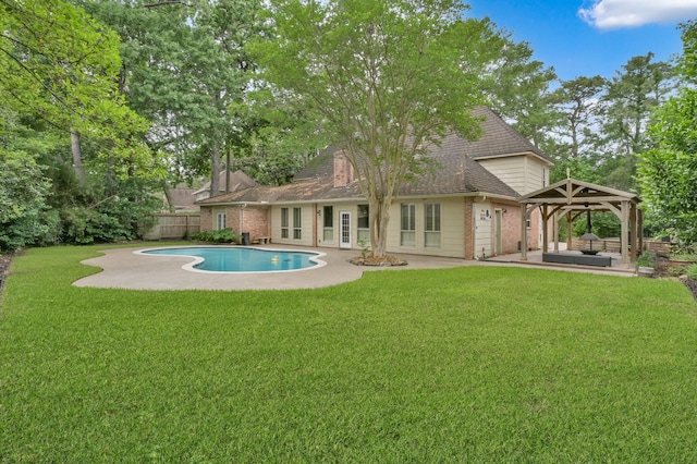 back of property with fence, a gazebo, a yard, and a patio