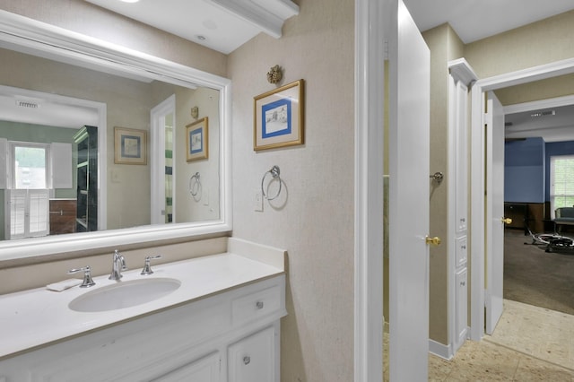 bathroom with baseboards, visible vents, and vanity