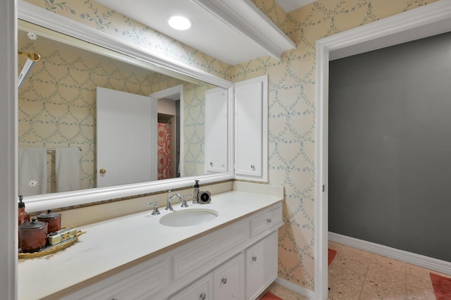bathroom with vanity and baseboards