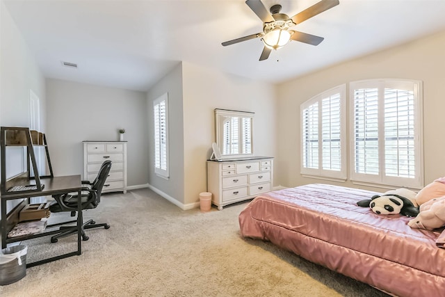 carpeted bedroom featuring visible vents, ceiling fan, and baseboards