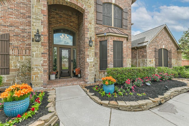 doorway to property featuring brick siding