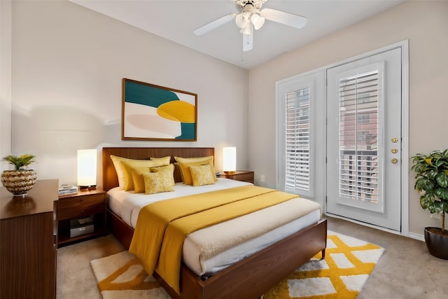 bedroom featuring a ceiling fan, baseboards, light colored carpet, and access to exterior