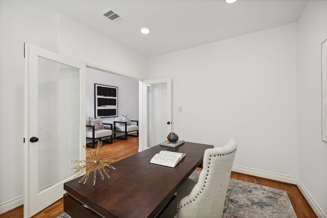 home office with recessed lighting, baseboards, visible vents, and wood finished floors