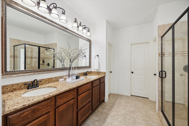 full bathroom featuring double vanity, tile patterned floors, a sink, and a stall shower