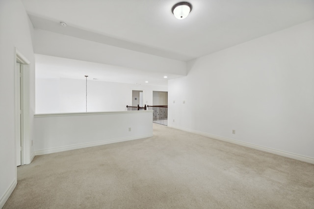 unfurnished room with recessed lighting, baseboards, and light colored carpet