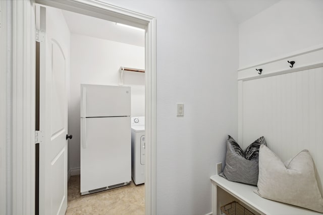 mudroom with light tile patterned floors and washer / clothes dryer