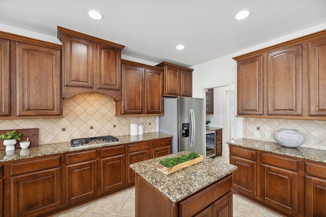 kitchen with backsplash, light stone counters, wine cooler, stainless steel appliances, and recessed lighting