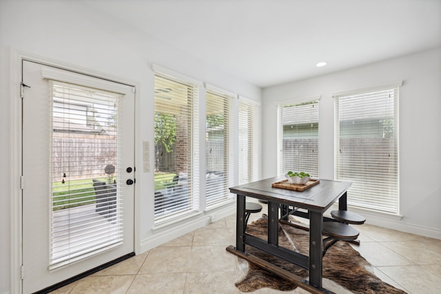doorway featuring light tile patterned flooring, baseboards, recessed lighting, and a wealth of natural light