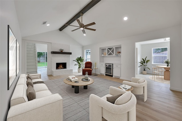 1503 Bamwick Dr, Houston, TX 77090 - living room featuring wine cooler, light wood finished floors, a fireplace, a dry bar, and ceiling fan