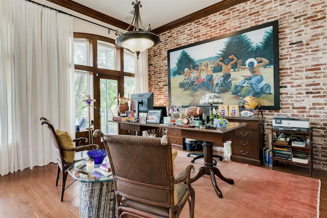 office area with wood finished floors, brick wall, and ornamental molding