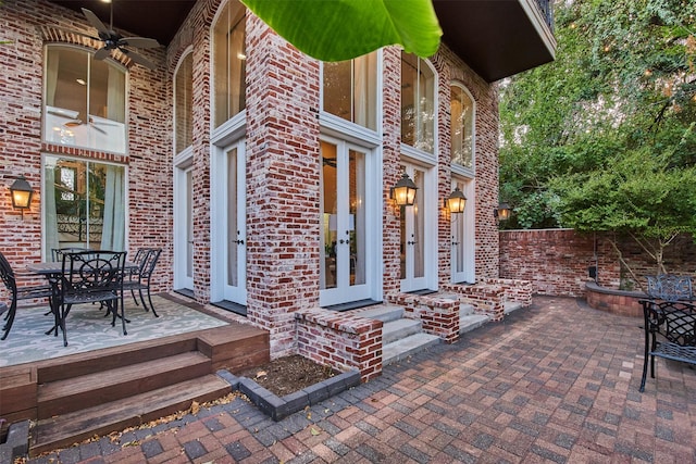 view of patio with french doors, outdoor dining area, and a ceiling fan