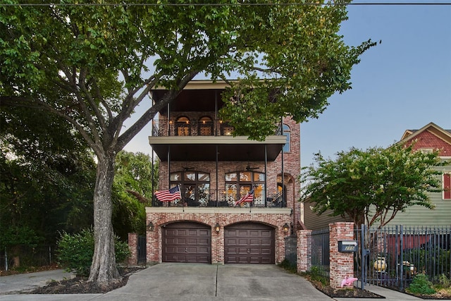 view of front of property with concrete driveway, a balcony, fence, brick siding, and a garage