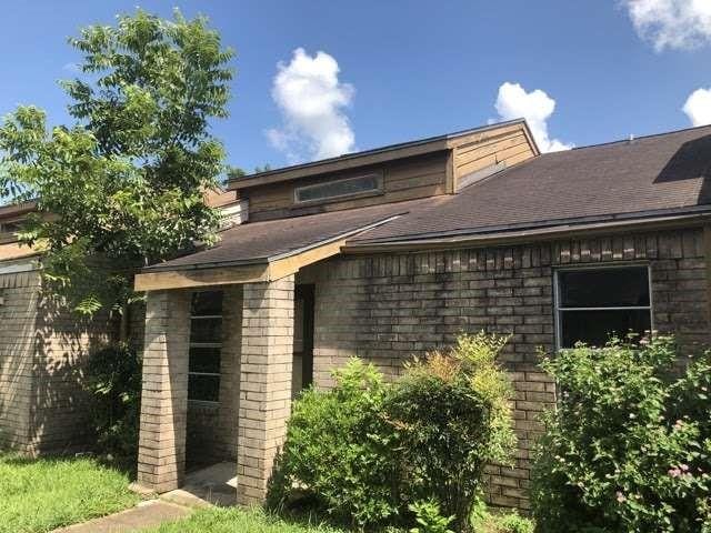 811 Buchta Rd Unit C, Angleton, TX 77515 - rear view of property with a shingled roof and brick siding